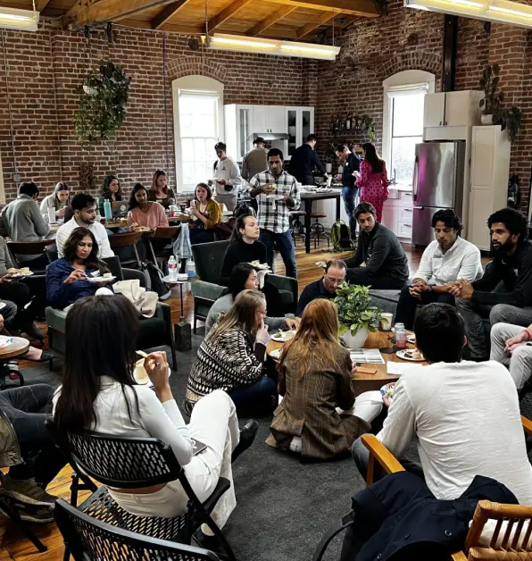 Attendees talking in small groups in a shared event space